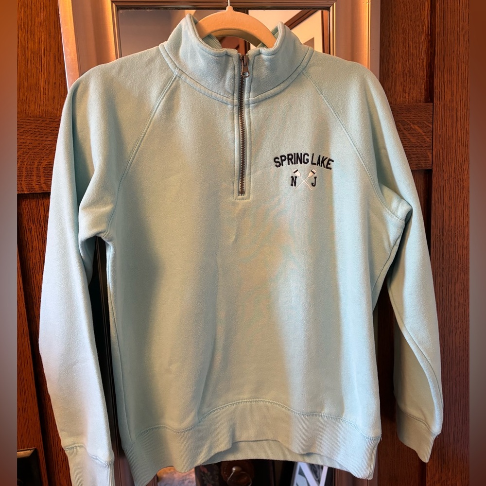Light blue half zip sweater/sweatshirt with Spring Lake emblem.
